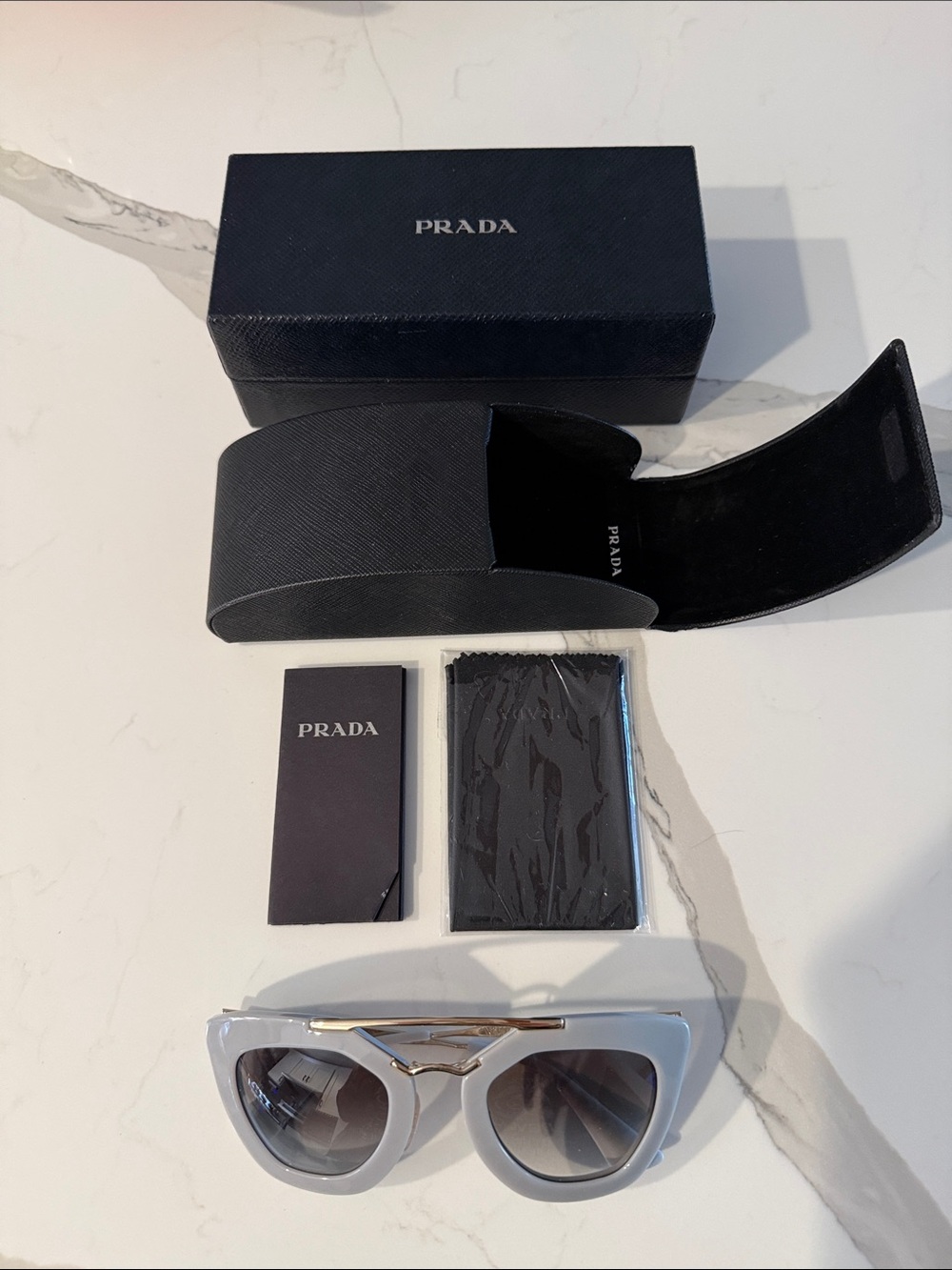 Prada Women's Cinema Grey Sunglasses with Gold Accent